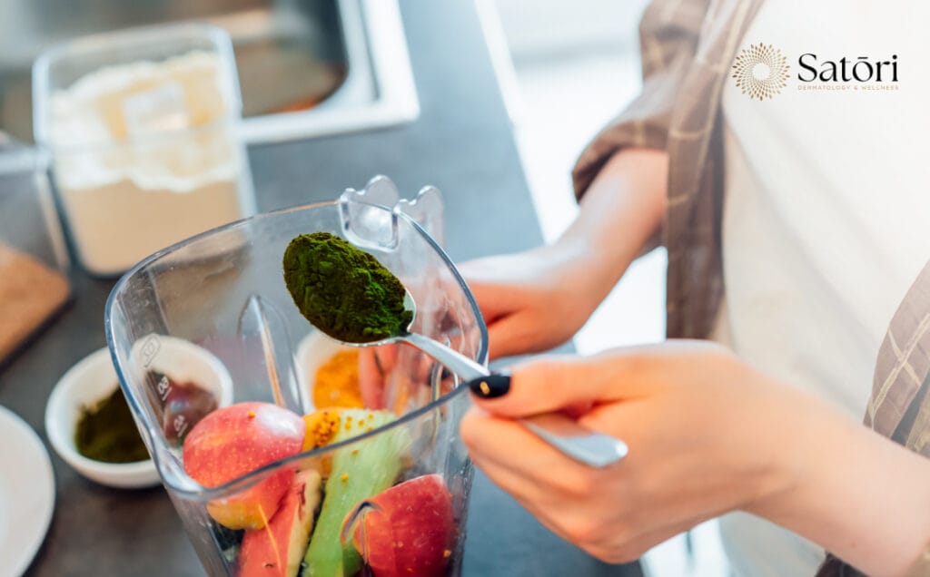 Woman preparing a fruit smoothie as a natural energy-boosting alternative to coffee.