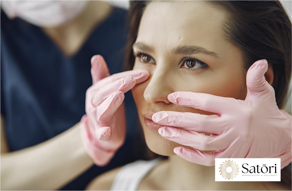 Dermatologist closely examining a patient's under-eye area to assess fine lines, wrinkles, and skin texture.