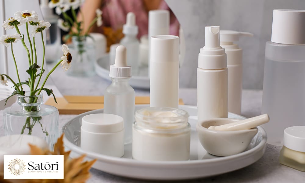 Skincare products for women in their 30s arranged neatly on a vanity tray.